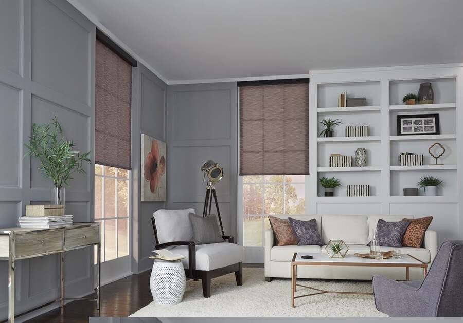 A living space featuring half-lowered Lutron shades.