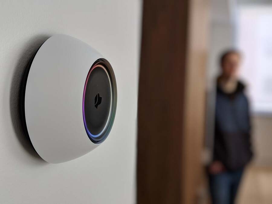 A Sonos music system installed in the living room of a home next to a sofa