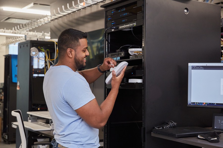 Technician adding equipment to a Control4 rack.