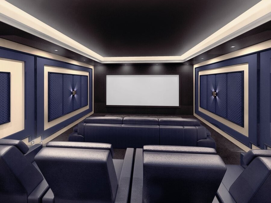 A home theater space featuring a large screen display, theater seating, and acoustic paneling.