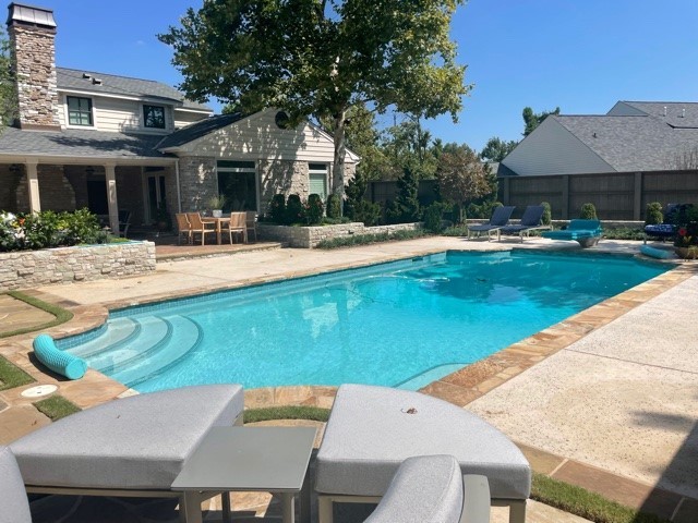  pool view with outdoor speakers hidden among landscaping